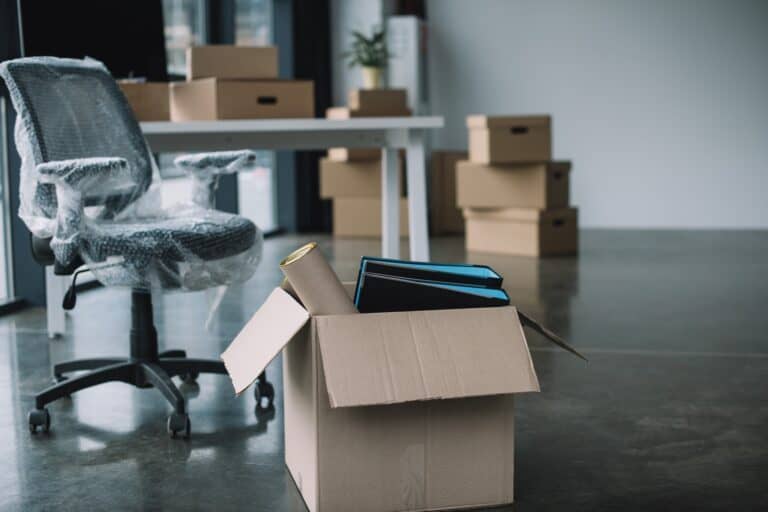 Cardboard boxes and wrapped chair in the office for an office move