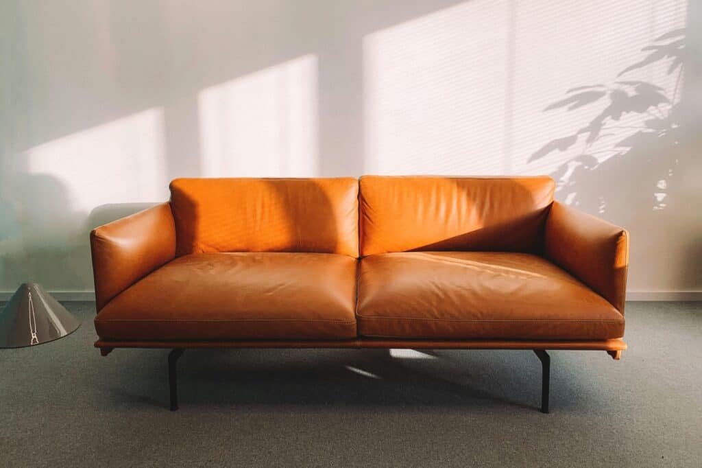 A bulky orange leather sofa