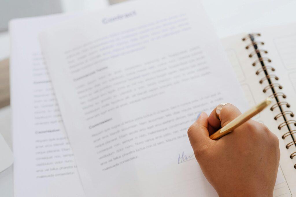 A closeup of a woman's hand signing a contract